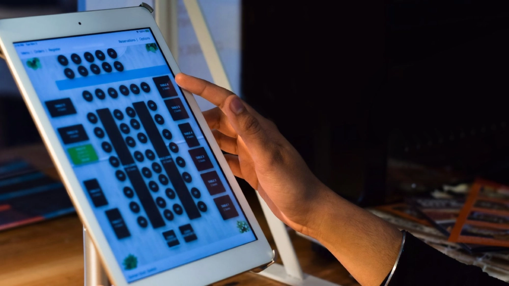 A person using an ipad with a keyboard on it.