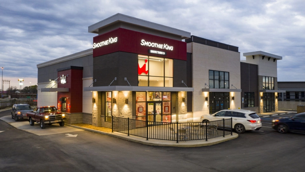 A large building with a car parked in front of it.